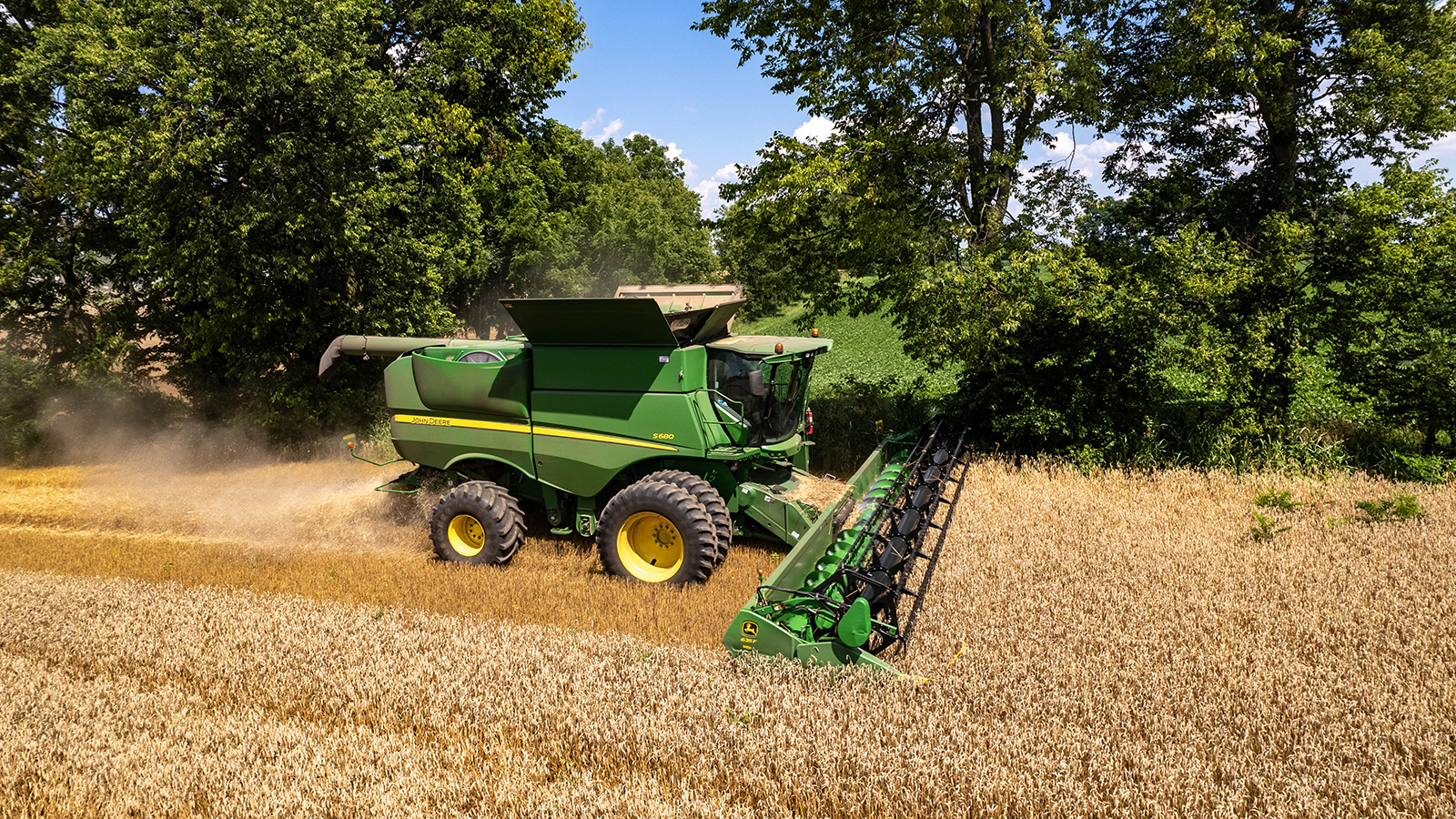 Green combine harvesting wheat in Kentucky.